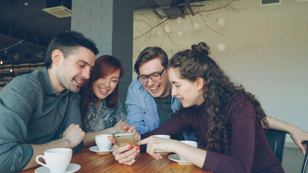 group of friends watching video on phone