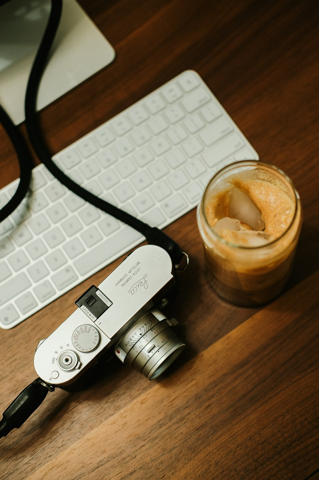 Filmmaker desk with a mirrorless camera, notebook and coffee cup
