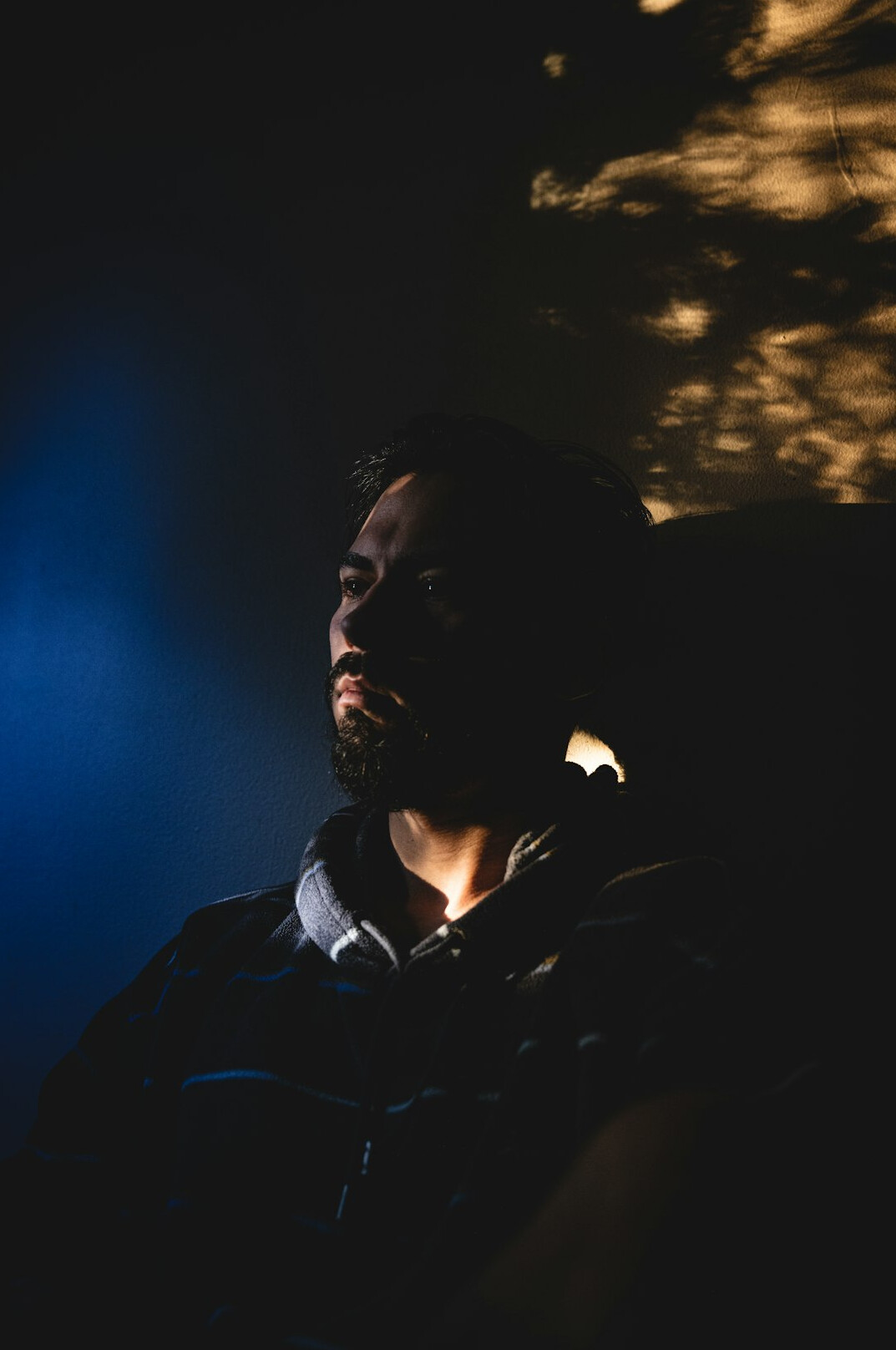 Studio portrait of a man cinematographer with a beard