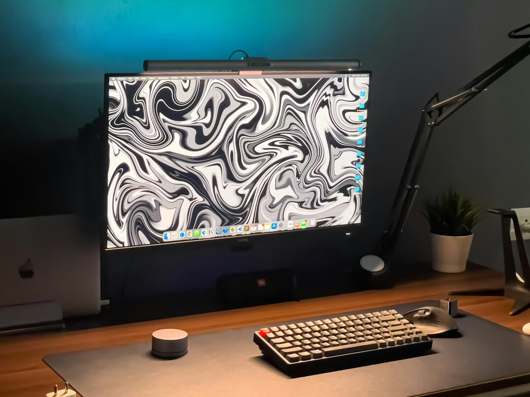 Video editing suite with multiple monitors showing a timeline and colour grading panels